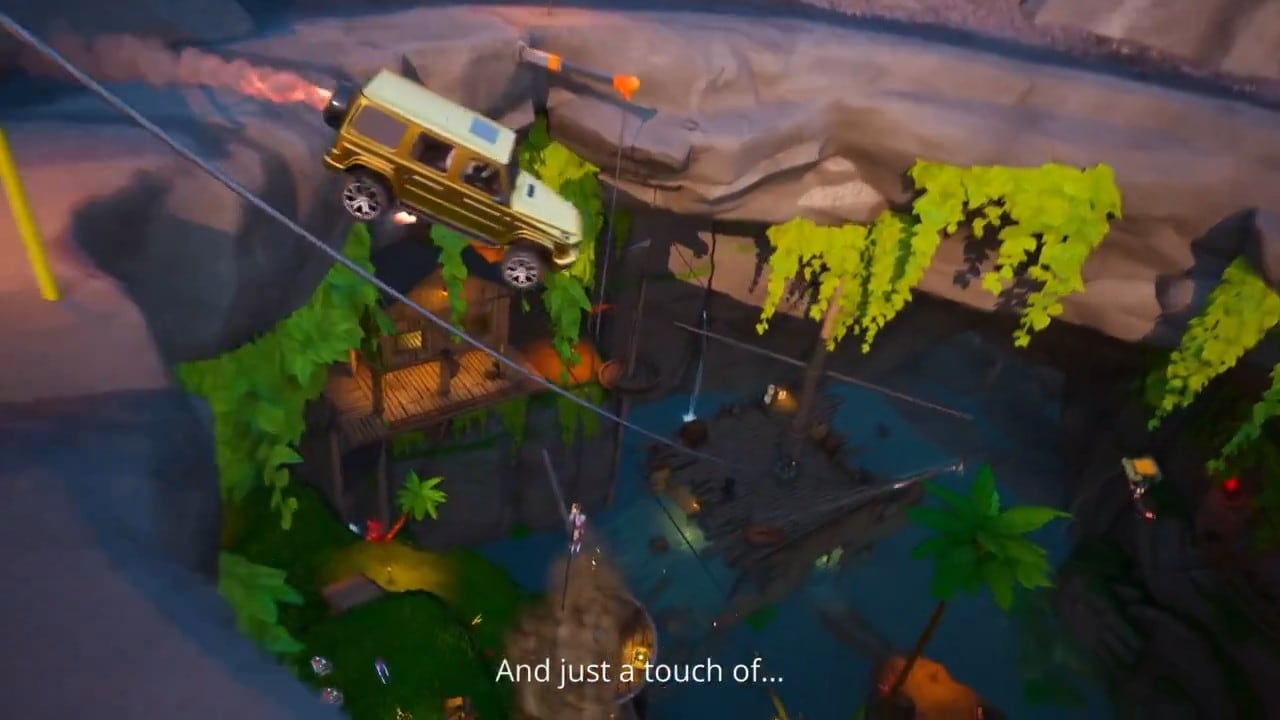A golden car drops into a huge rocky cave with hanging vines, seen from above, with wooden walkways and a zip line inside.